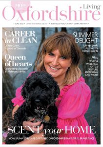 Cover of Oxfordshire Living Magazine Lady in a pink dress holding a black scruffy dog